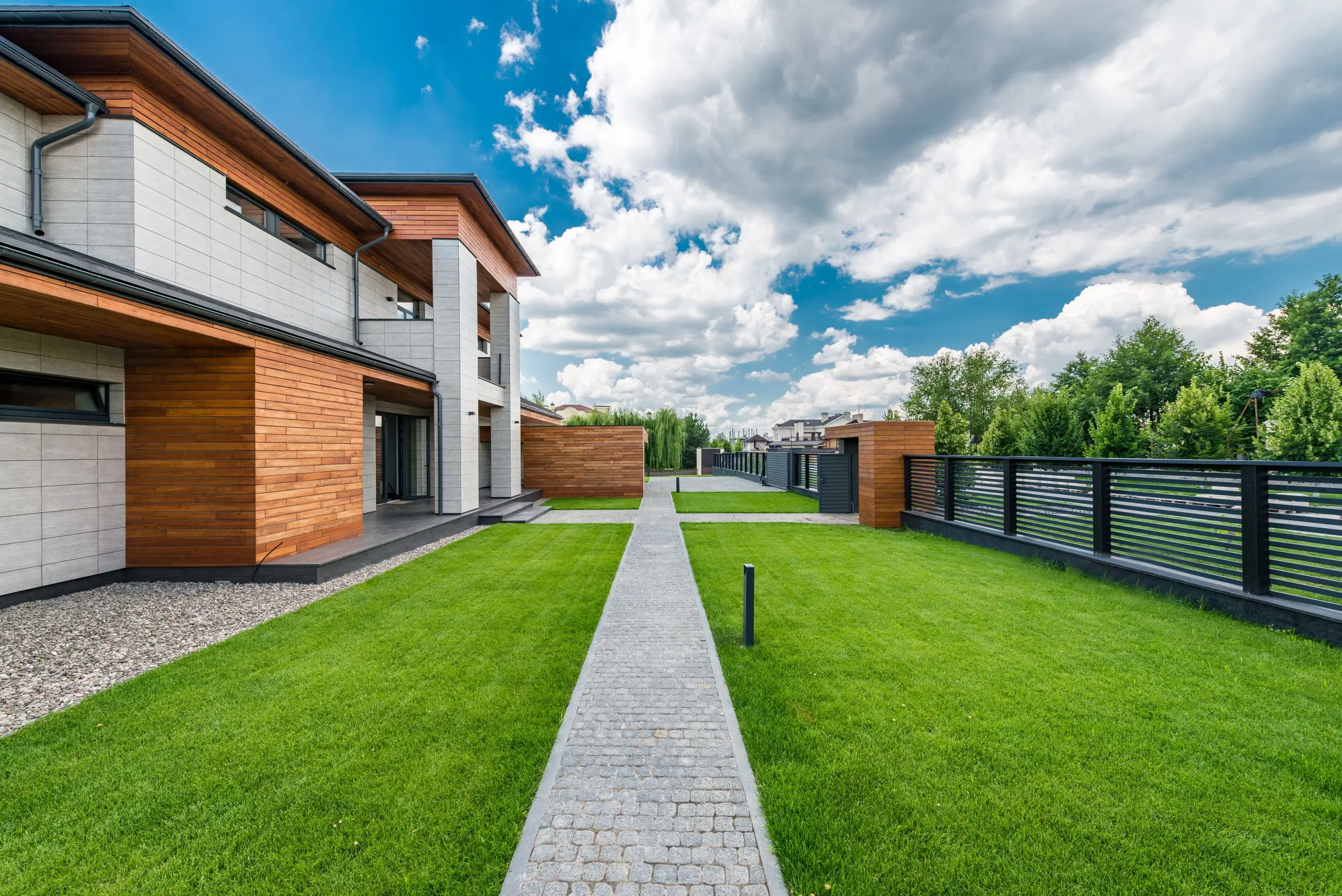 Wood and stone home exterior with a manicured lawn